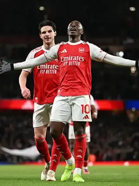 Footballers celebrating a goal during a live match